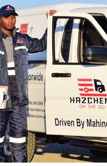A Hazchem on the Go crew member in uniform at a branded delivery vehicle